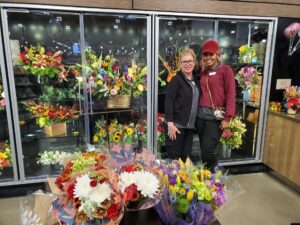 two women standing in a flower shop