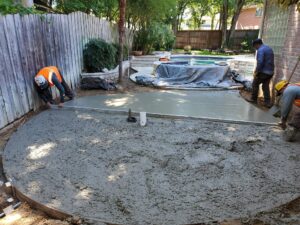 concrete being poured and laid for a patio