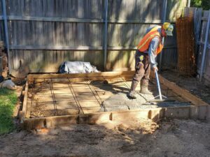 concrete being poured and laid for a patio